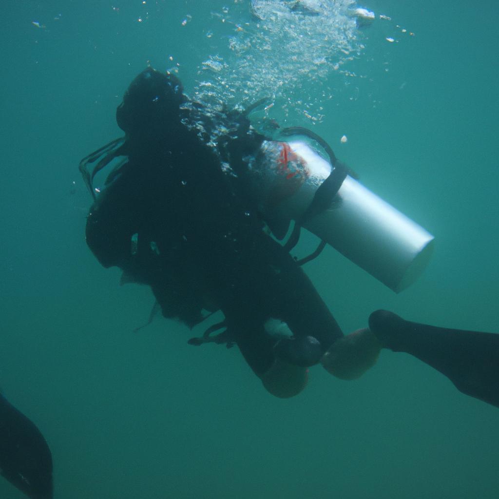 Person diving underwater with equipment